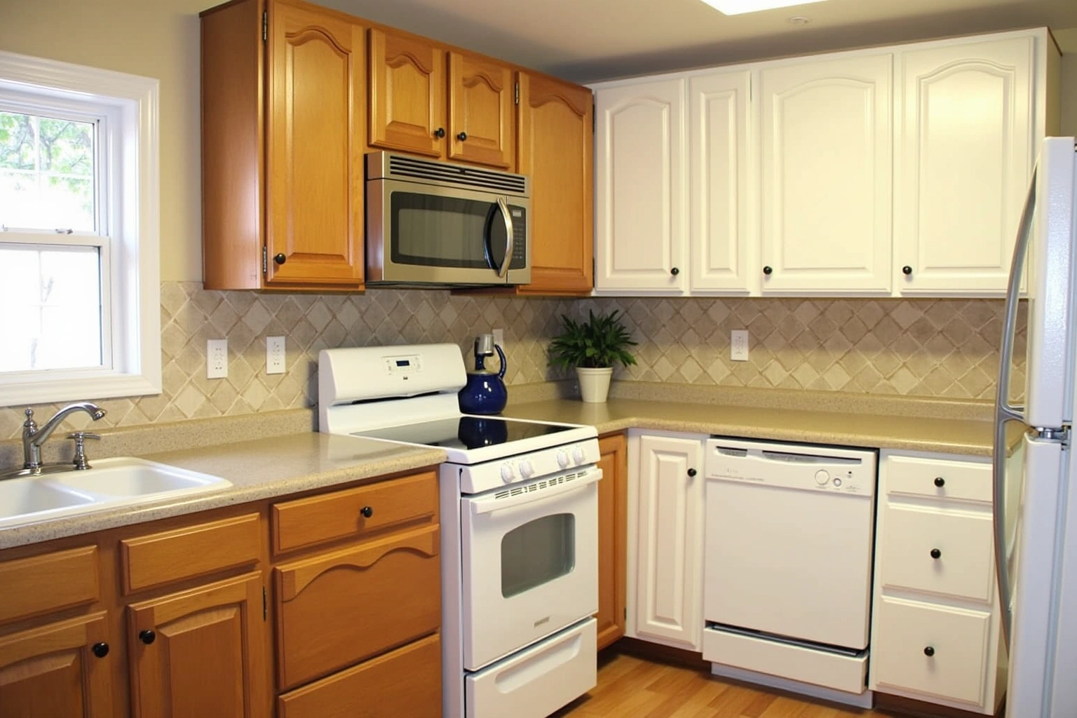 Kitchen halfway through refacing, golden oak arched doors still on the left and new white doors hung on the right.
